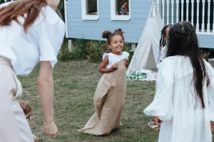 Three children playing in their front yard.