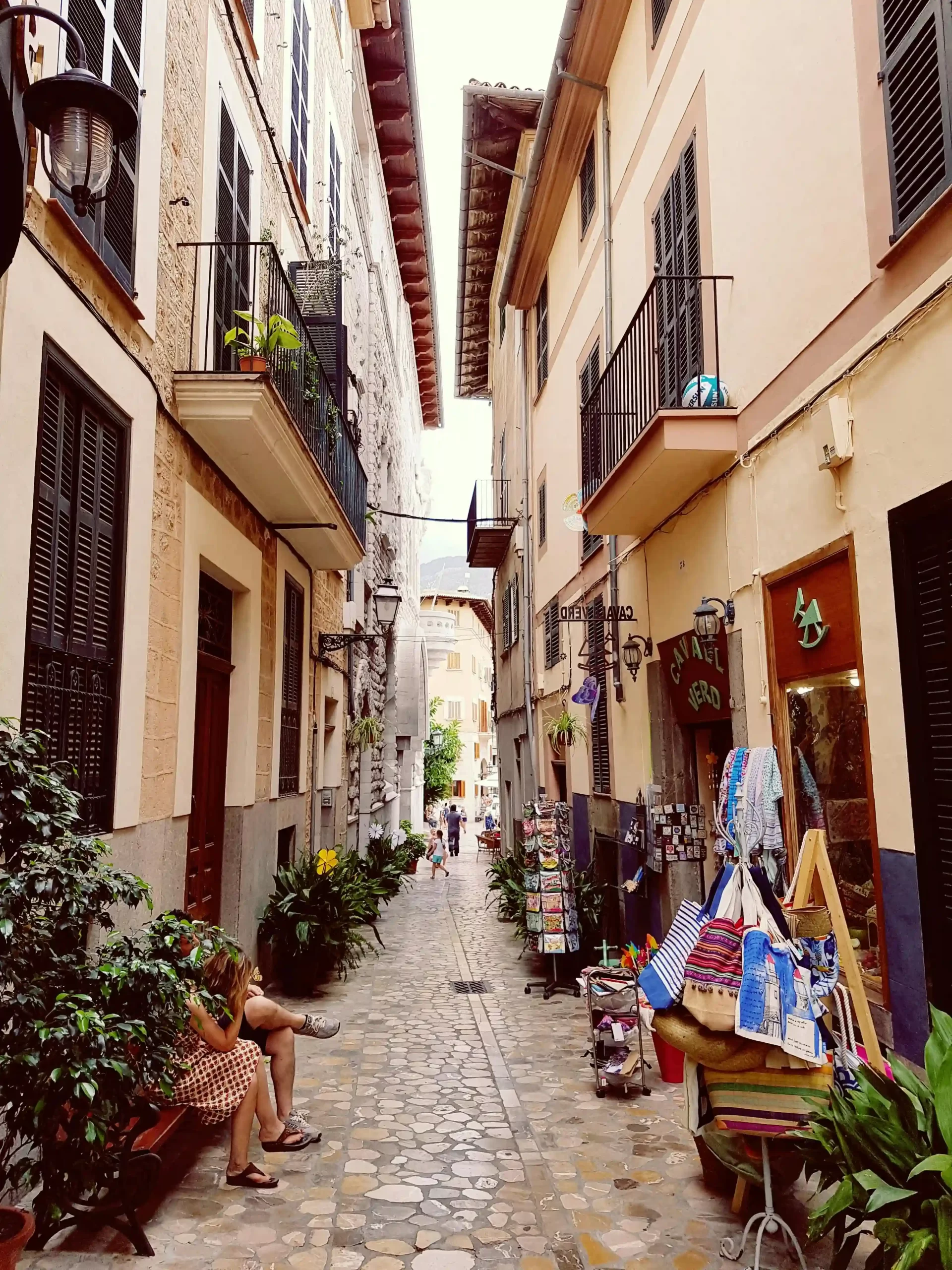 A Spanish town with tall buildings and cast iron balconies.