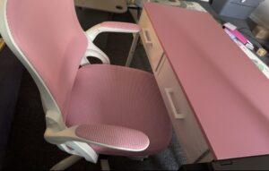 A pink office desk and pink office chair
