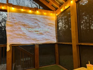 A movie being projected onto a white sheet, representing fun family ideas for at home.