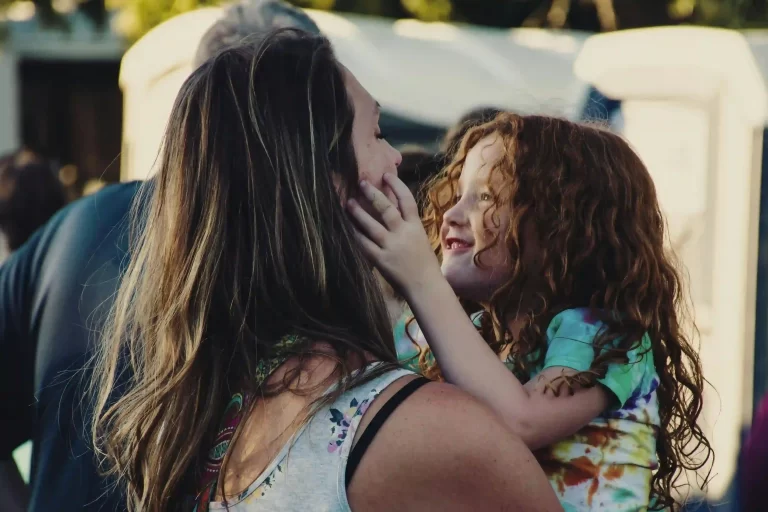 A mother and daughter smiling at each other, representing how work-from-home parents can connect with their kids