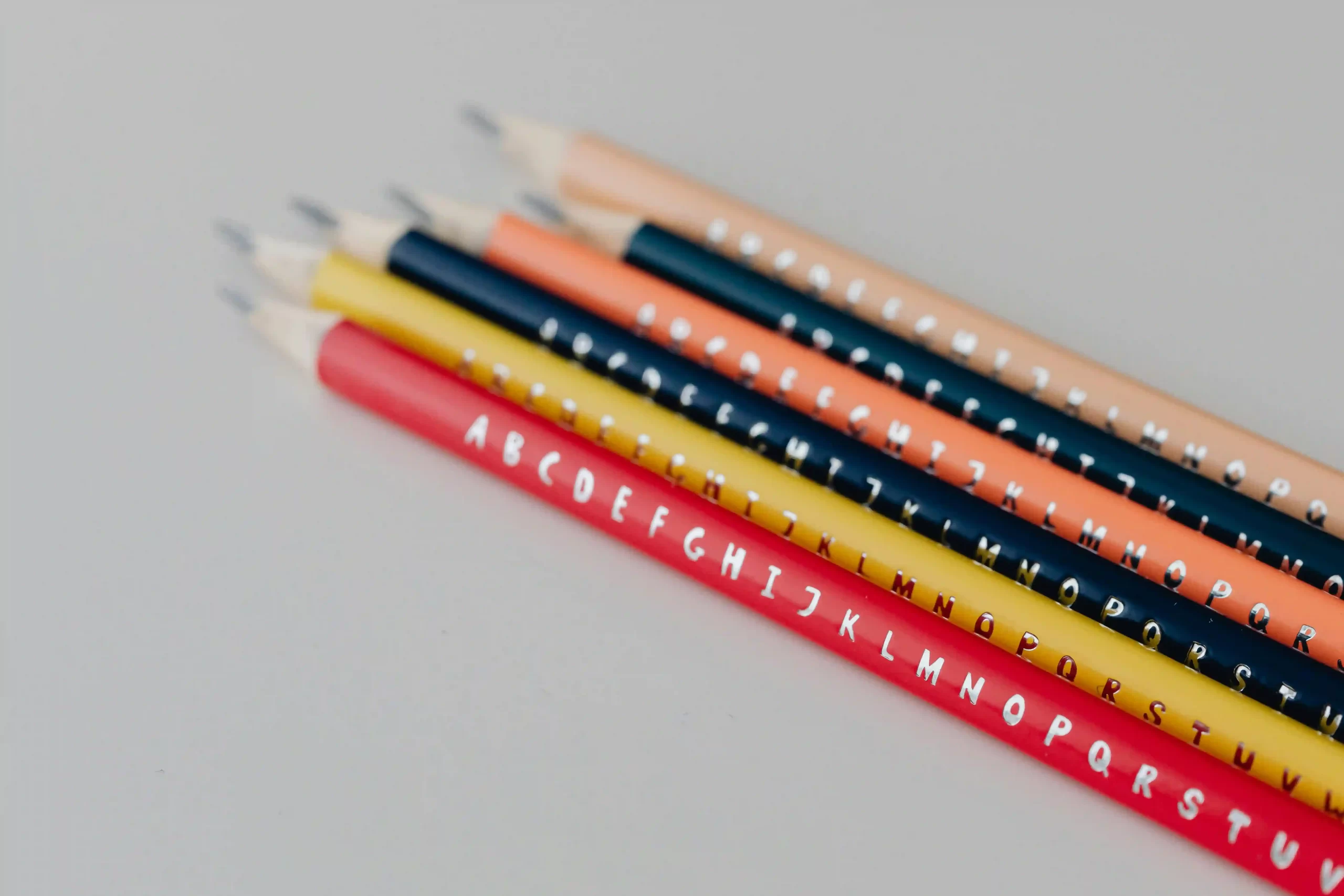 several pencils engraved with the alphabet