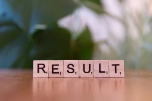 Scrabble tiles spelling out the word "RESULT".