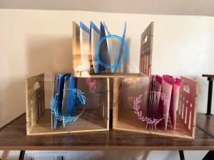 three wooden and acrylic boxes representing a homeschool file storage