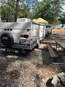 a pop-up camper, hitched to a car