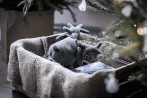 A black and white image of a crate box underneath a Christmas tree, representing Christmas Eve box ideas