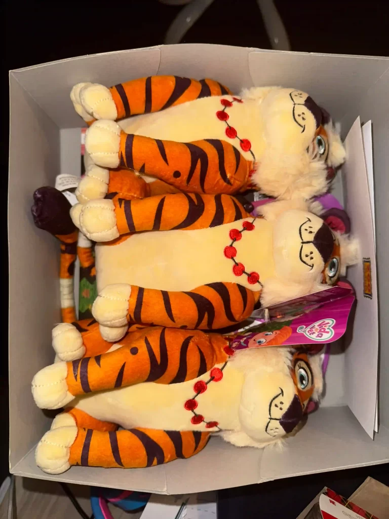 Three toy tigers in a box, representing learning toys for homeschoolers.