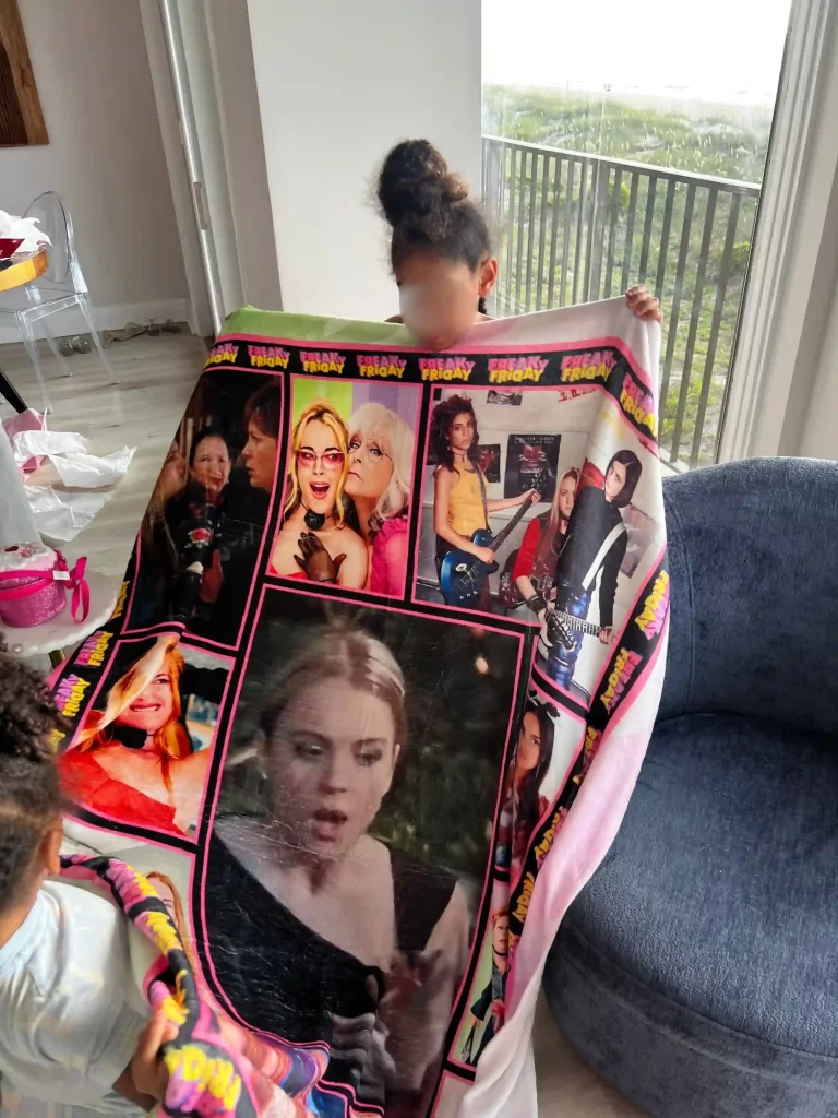 A young child holding a Freaky-Friday themed blanket, representing movie-inspired birthday parties