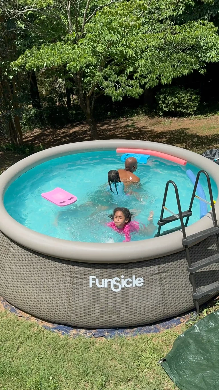 Three family members swimming in an outdoor pool, representing how to teach water safety at home